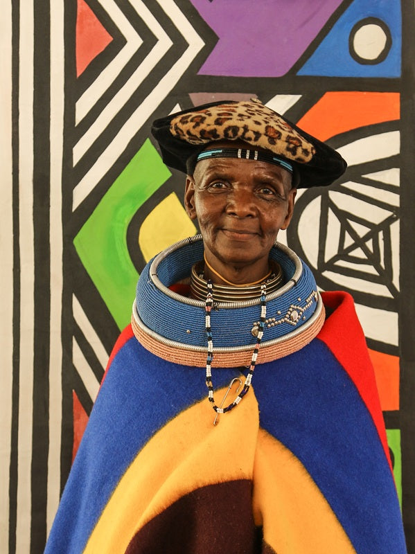 Close-up portrait of an Ndebele woman in traditional beaded dress and brass neck rings, fine art photography by Suzanne Morshead, South Africa.